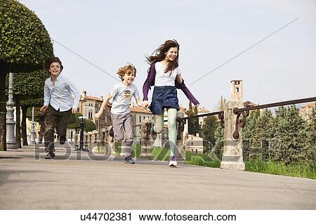 Young boys and older sister running through park, Province of Venice, Italy View Large Photo Image Stock Image - Young boys and older sister running through park, Province of Venice, Italy. Fotosearch