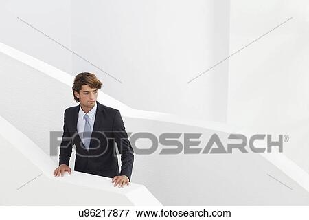 Young businessman waiting on stairs View Large Photo Image Stock Photo - Young businessman waiting on stairs. Fotosearch