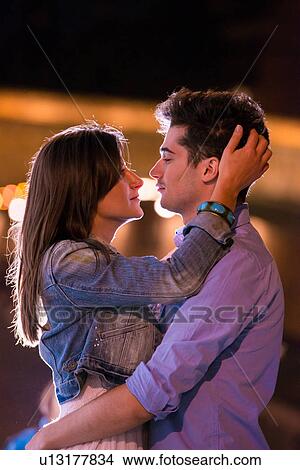 Young couple embracing at night, Paris, France View Large Photo Image Picture - Young couple embracing at night, Paris, France. Fotosearch