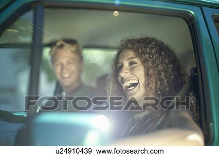 Young couple enjoying road trip in car View Large Photo Image Stock Photo - Young couple enjoying road trip in car. Fotosearch
