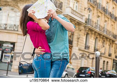 Young couple hiding behind map, Paris, France View Large Photo Image Picture - Young couple hiding behind map, Paris, France. Fotosearch