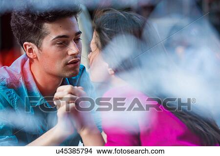 Picture - Young couple holding hands at pavement cafe, Paris, France. Fotosearch