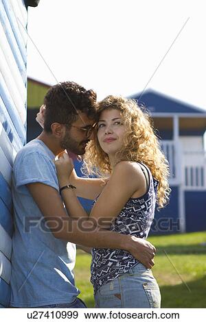 Young couple hugging by beach hut View Large Photo Image Stock Photo - Young couple hugging by beach hut. Fotosearch