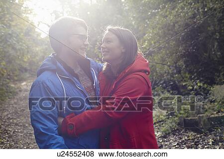 Young couple hugging in woods View Large Photo Image Stock Photo - Young couple hugging in woods. Fotosearch