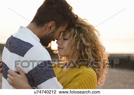 Young couple hugging on beach View Large Photo Image Stock Image - Young couple hugging on beach. Fotosearch