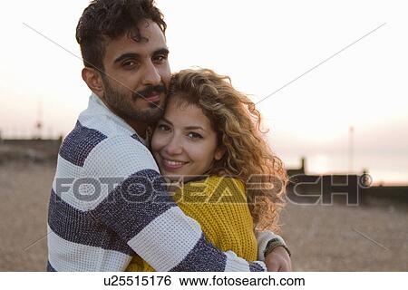 Young couple hugging on beach View Large Photo Image Stock Photograph - Young couple hugging on beach. Fotosearch
