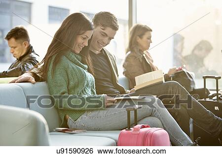 Young couple in departure lounge View Large Photo Image Stock Photograph - Young couple in departure lounge. Fotosearch