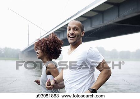 Young couple jogging by bridge, Dusseldorf, Germany View Large Photo Image Stock Image - Young couple jogging by bridge, Dusseldorf, Germany. Fotosearch
