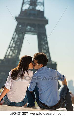 Young couple kissing in front of Eiffel Tower, Paris, France View Large Photo Image Stock Photo - Young couple kissing in front of Eiffel Tower, Paris, France. Fotosearch