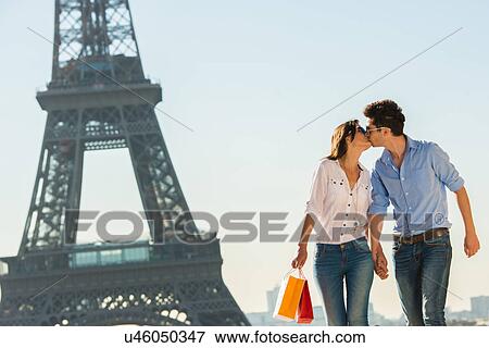 Young couple kissing near Eiffel Tower, Paris, France View Large Photo Image Stock Photo - Young couple kissing near Eiffel Tower, Paris, France. Fotosearch