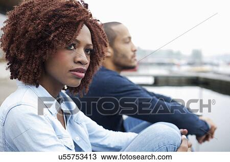 Stock Image - Young couple looking away. Fotosearch