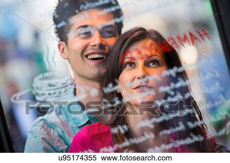 Young couple reading cafe window menu, Paris, France View Large Photo Image Stock Photography - Young couple reading cafe window menu, Paris, France. Fotosearch