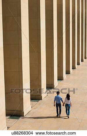Young couple walking hand in hand, Paris, France View Large Photo Image Picture - Young couple walking hand in hand, Paris, France. Fotosearch