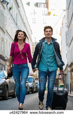 Young couple with wheeled suitcase, Paris, France View Large Photo Image Picture - Young couple with wheeled suitcase, Paris, France. Fotosearch