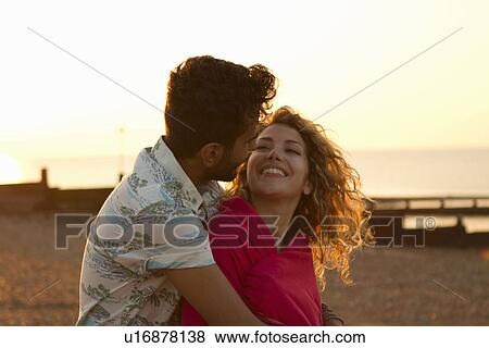 Young couple wrapped in towel on beach View Large Photo Image Stock Photo - Young couple wrapped in towel on beach. Fotosearch
