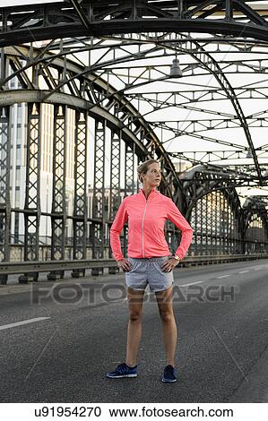 Young female runner exercising on bridge View Large Photo Image Stock Image - Young female runner exercising on bridge. Fotosearch
