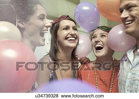 Young friends celebrating at party View Large Photo Image Stock Photo - Young friends celebrating at party. Fotosearch