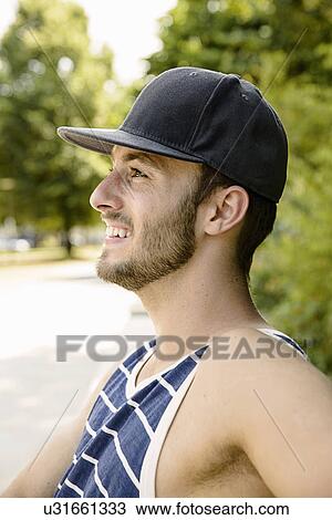 Young male basketball player taking a break in park View Large Photo Image Stock Image - Young male basketball player taking a break in park. Fotosearch