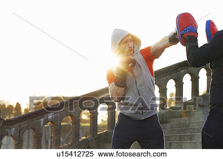 Young man boxing training with teacher View Large Photo Image Stock Photography - Young man boxing training with teacher. Fotosearch