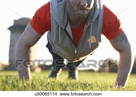 Young man doing push ups View Large Photo Image Picture - Young man doing push ups. Fotosearch