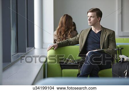 Young man in departure lounge View Large Photo Image Picture - Young man in departure lounge. Fotosearch