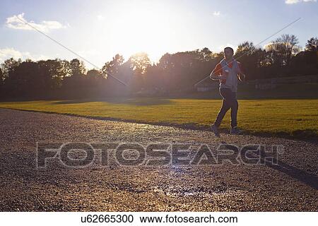 Young man jogging in park View Large Photo Image Stock Image - Young man jogging in park. Fotosearch