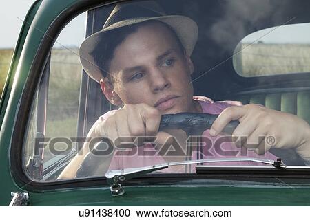 Young man looking through windscreen of vintage morris minor View Large Photo Image Stock Image - Young man looking through windscreen of vintage morris minor. Fotosearch