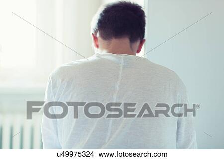 Young man sitting with head down View Large Photo Image Picture - Young man sitting with head down. Fotosearch