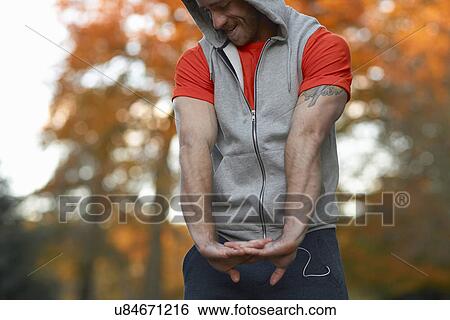 Young man stretching arms View Large Photo Image Stock Photograph - Young man stretching arms. Fotosearch