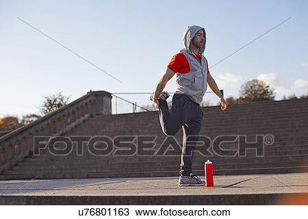 Young man stretching leg View Large Photo Image Stock Image - Young man stretching leg. Fotosearch