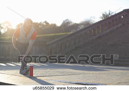 Young man stretching leg View Large Photo Image Stock Photo - Young man stretching leg. Fotosearch