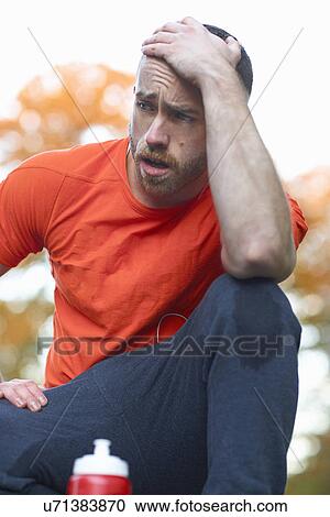 Young man with head in hands View Large Photo Image Stock Image - Young man with head in hands. Fotosearch