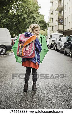 Young schoolgirl carrying umbrella View Large Photo Image Stock Image - Young schoolgirl carrying umbrella. Fotosearch