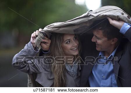 Young woman and mature man walking in park View Large Photo Image Stock Image - Young woman and mature man walking in park. Fotosearch