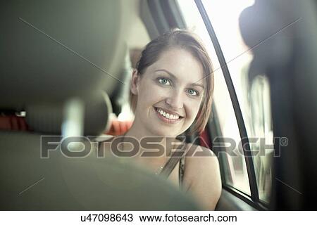 Young woman in back seat of car View Large Photo Image Stock Image - Young woman in back seat of car. Fotosearch