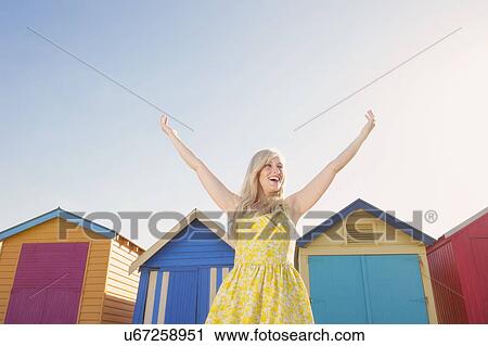 Young woman in front of beach huts, Melbourne, Australia View Large Photo Image Stock Image - Young woman in front of beach huts, Melbourne, Australia. Fotosearch