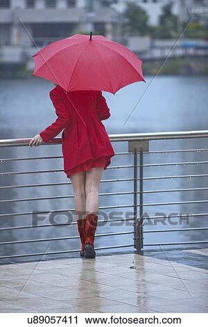 Young woman in red waiting by waterfront View Large Photo Image Stock Image - Young woman in red waiting by waterfront. Fotosearch