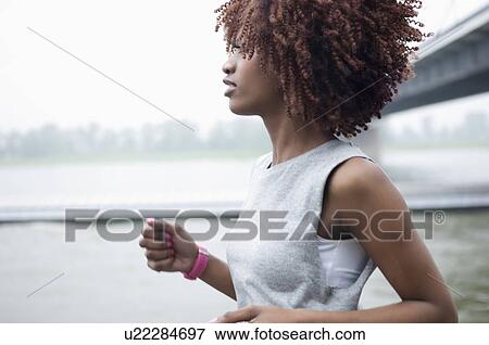 Young woman jogging by bridge, Dusseldorf, Germany View Large Photo Image Stock Photo - Young woman jogging by bridge, Dusseldorf, Germany. Fotosearch