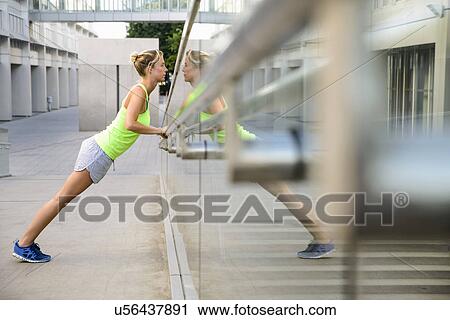Young woman leaning and stretching View Large Photo Image Stock Image - Young woman leaning and stretching. Fotosearch