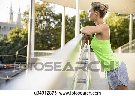Young woman leaning on railing View Large Photo Image Stock Photography - Young woman leaning on railing. Fotosearch