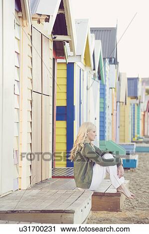 Young woman sitting next to beach huts, Melbourne, Australia View Large Photo Image Stock Image - Young woman sitting next to beach huts, Melbourne, Australia. Fotosearch