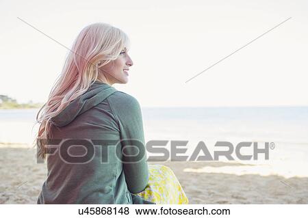 Young woman sitting on beach, Melbourne, Australia View Large Photo Image Stock Photo - Young woman sitting on beach, Melbourne, Australia. Fotosearch