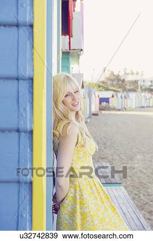 Young woman standing next to beach huts, Melbourne, Australia View Large Photo Image Stock Photo - Young woman standing next to beach huts, Melbourne, Australia. Fotosearch