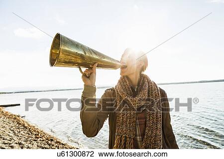Young woman using megaphone by lake View Large Photo Image Stock Image - Young woman using megaphone by lake. Fotosearch
