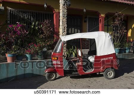 Stock Image - Auto rickshaw in front of a house, Barrio El Centro, Copan, Copan Ruinas, Honduras. Fotosearch