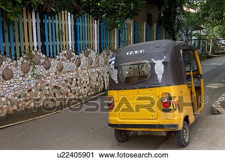 Stock Image - Auto rickshaw on the road, Utila Island, Bay Islands, Honduras. Fotosearch