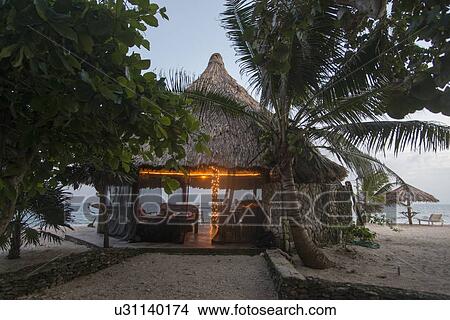 Beach hut at dusk, Utopia Village, Utila, Bay Islands, Honduras View Large Photo Image Picture - Beach hut at dusk, Utopia Village, Utila, Bay Islands, Honduras. Fotosearch