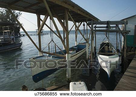 Boats at a dock, Cayman Cay, Utila Island, Bay Islands, Honduras View Large Photo Image Stock Photography - Boats at a dock, Cayman Cay, Utila Island, Bay Islands, Honduras. Fotosearch