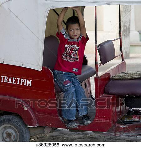Stock Photography - Boy in auto rickshaw, Barrio El Centro, Copan, Copan Ruinas, Honduras. Fotosearch