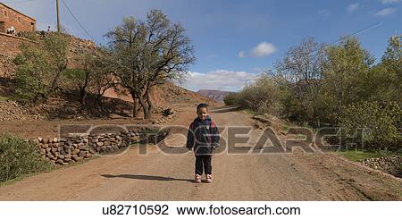 Boy walking on the dirt road, Morocco View Large Photo Image Stock Image - Boy walking on the dirt road, Morocco. Fotosearch